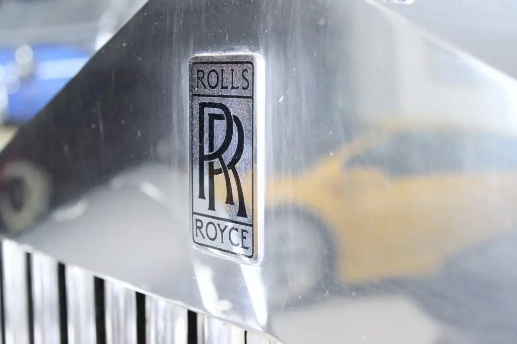 Close up of a black Rolls-Royce logo.