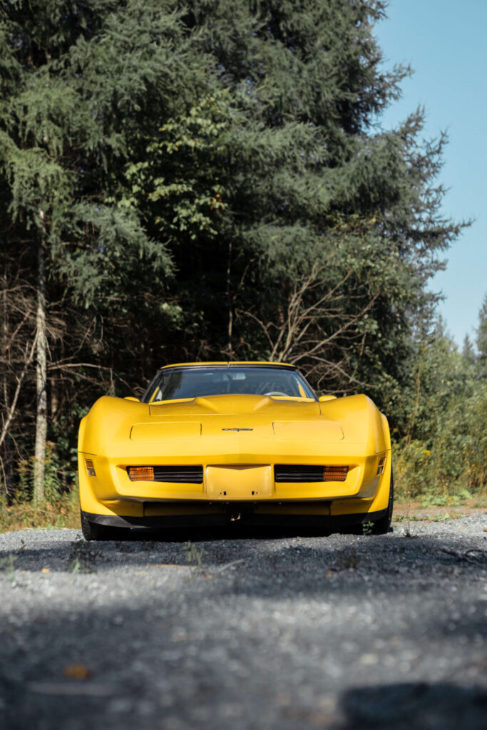 Front view of a 1980 yellow Corvette