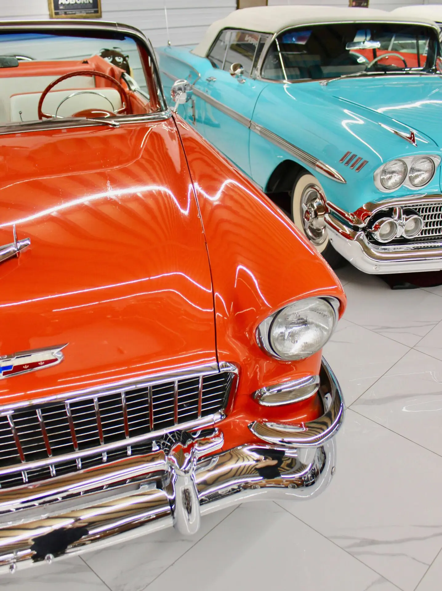 IMG_3184 Two old Chevrolet cars next to each other, one orange and one blue.