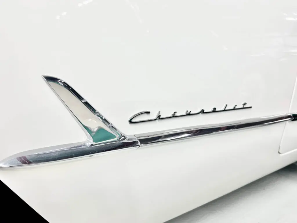 "Chevrolet" written in chrome on the flank of a white car