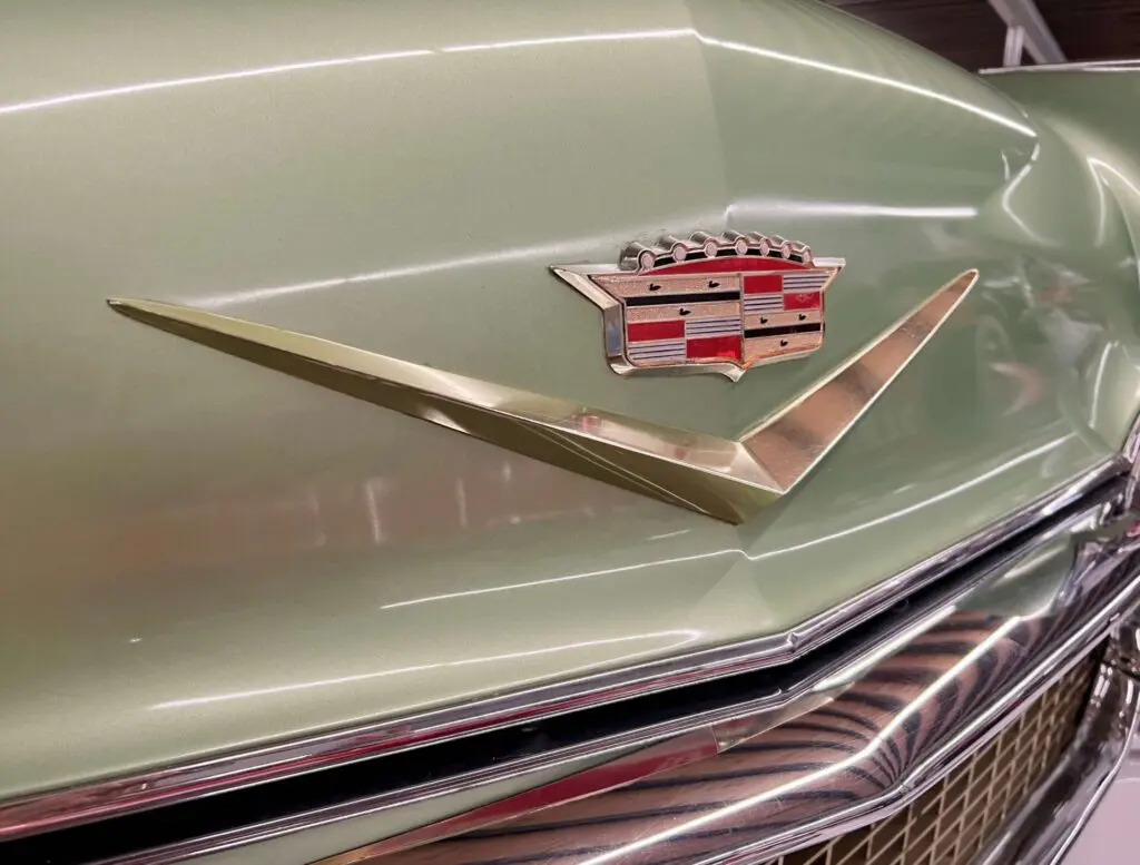 Close up of a Cadillac logo on a pale green car