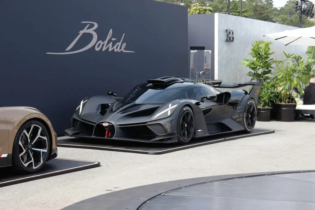 A cartoon-like sport car all in black with Xs in the headlights.