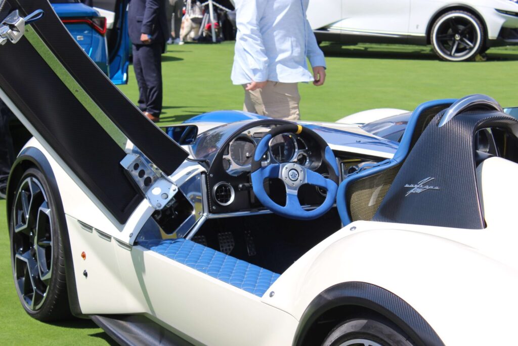 White vehicle with swan doors open