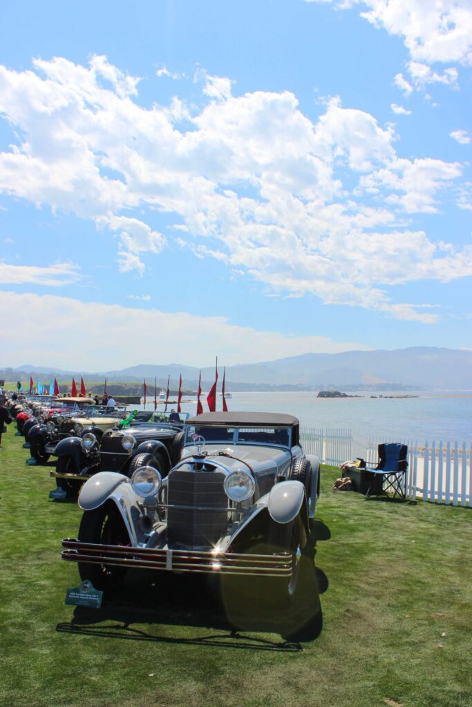 Cars line up by the side of the water at the Pebble Beach Concours d'Elegance 2023