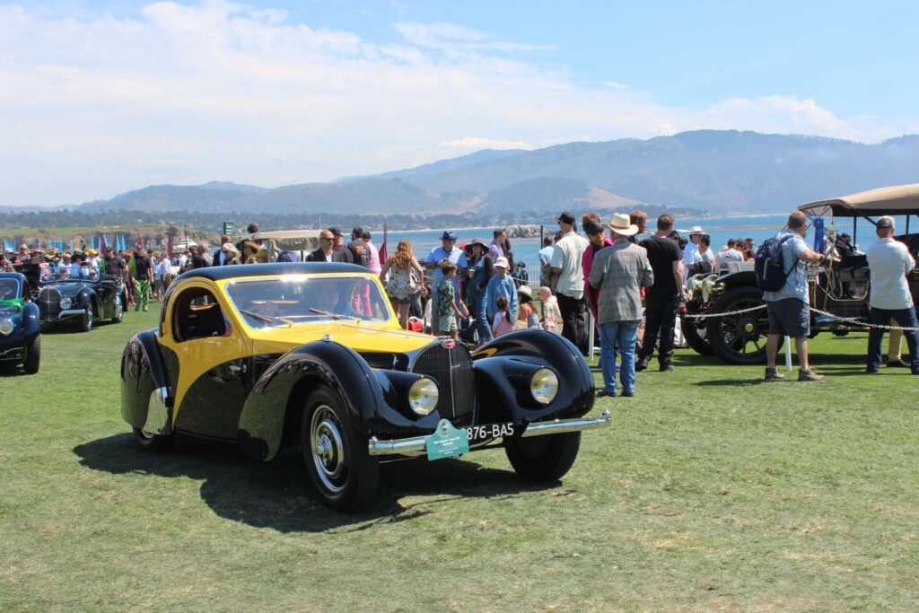 Black and yellow Bugatti in the crowd at the Pebble Beach Concours d'Elegance 2023