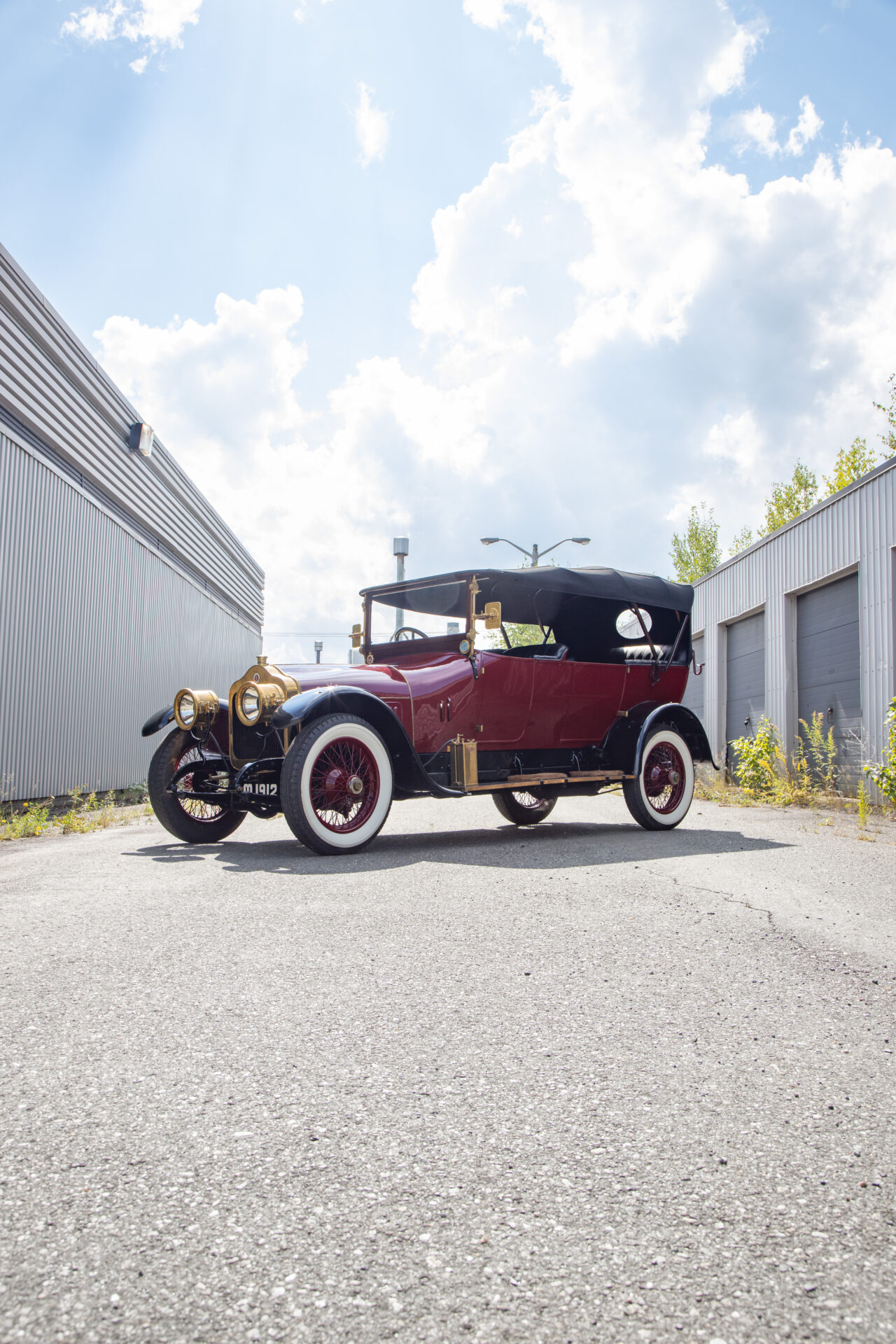 A maroon car with black folding roof of the Bronze Era: The Minerva Car