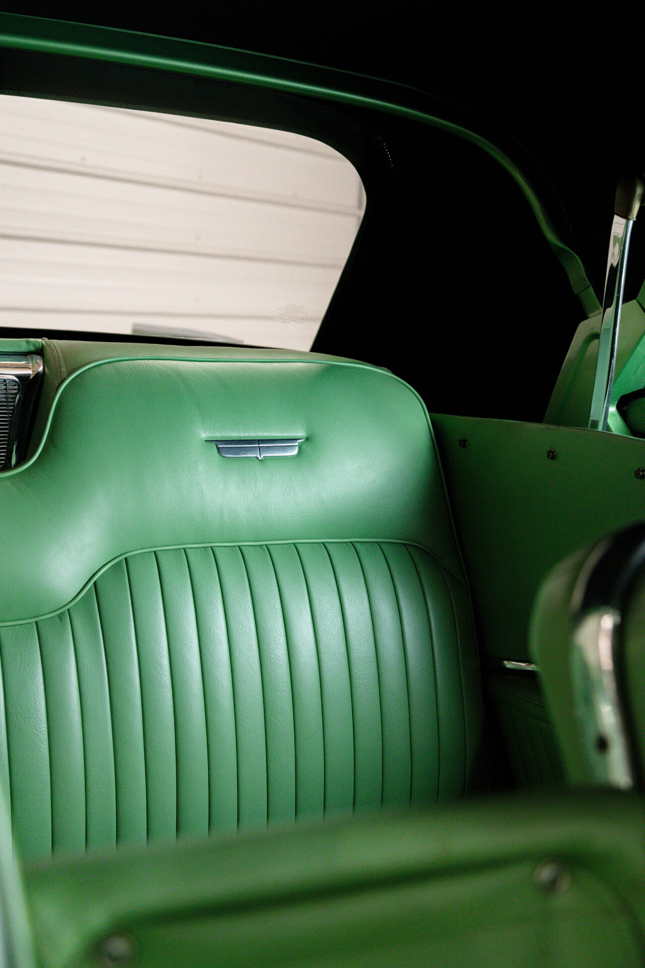 Lush green leather backseat of a 1957 Cadillac