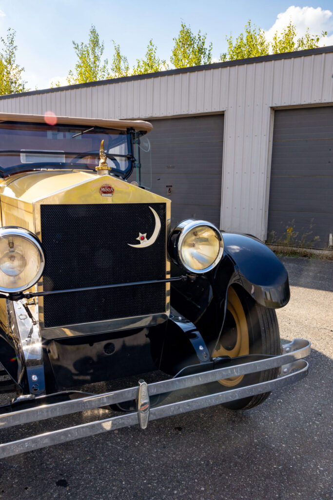 a closer look at the grille of the Moon car. It has a shape similar to a Roll-Royce's. a golden moon ornate the radiator cap as well as the top right corner of the black grille.