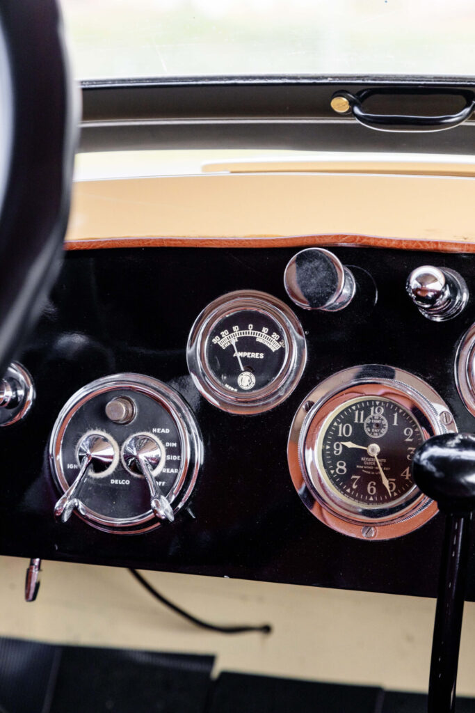 Close up view of the round gauges on al car dashboard from the 1920s.