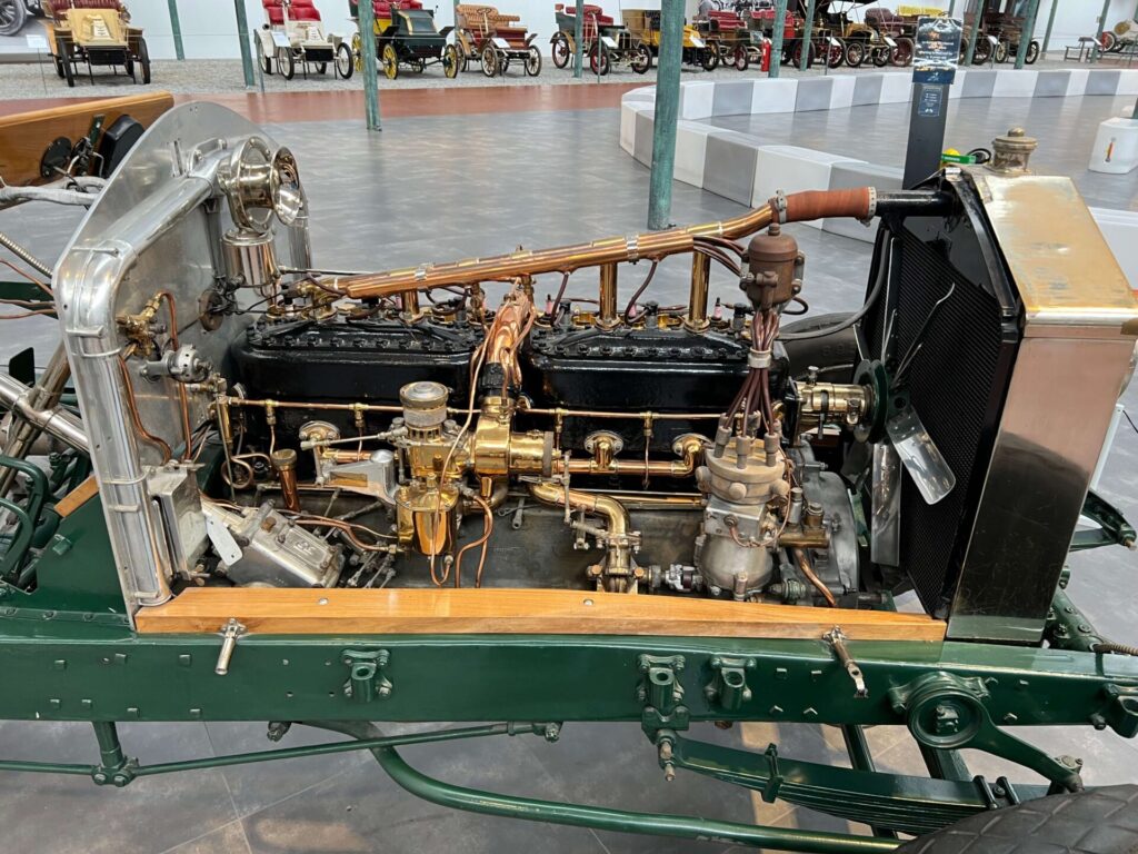 A Rolls-Royce chassis is put on display without the body of the car. The engine is made clearly visible.