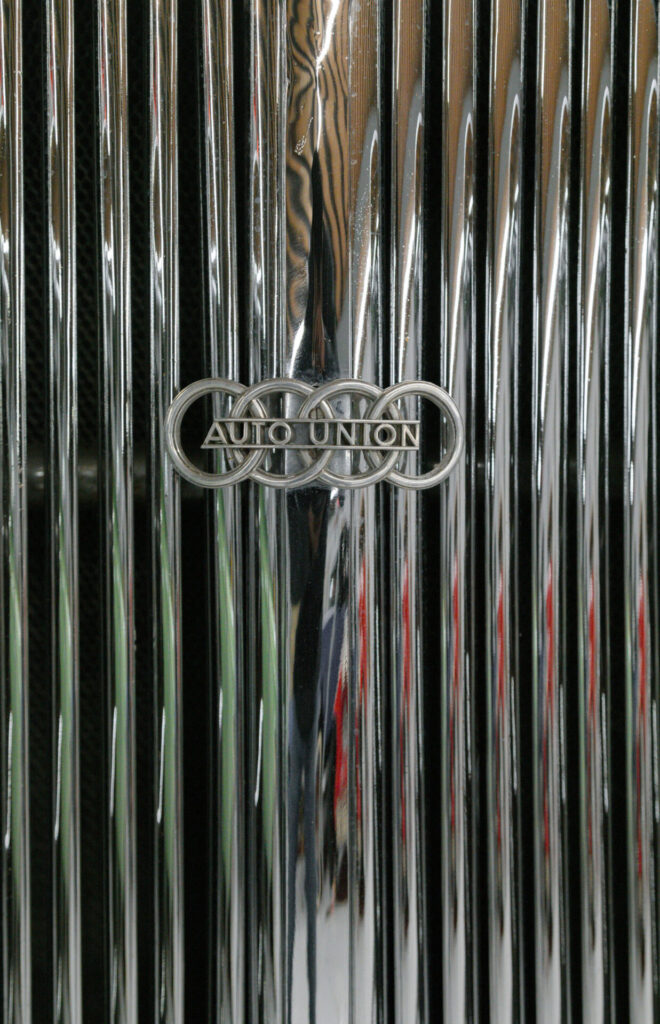 Auto Union logo on a silver grille. The logo is made of four horizontally interlocking rings with "Auto Union" written over them.