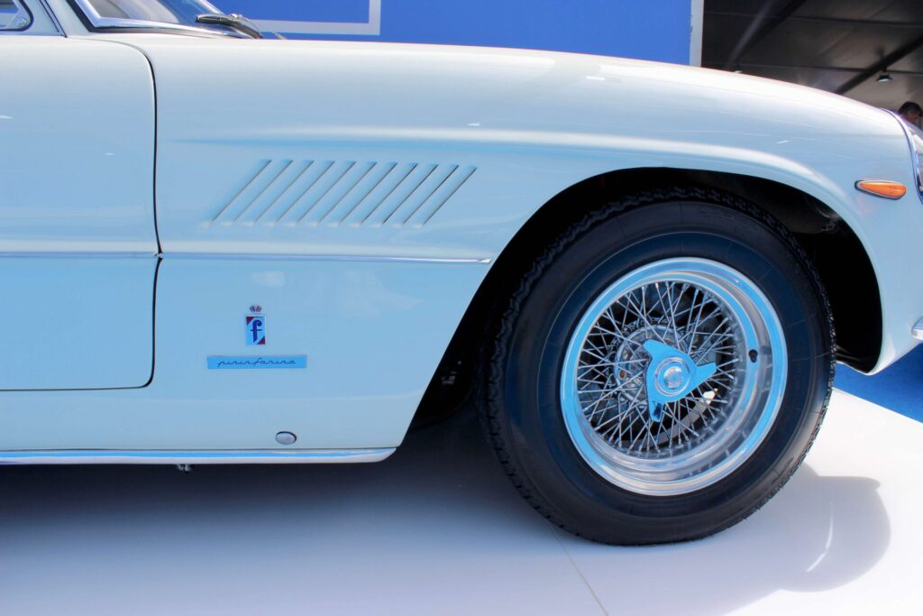 A Pininfarina badge on a white car